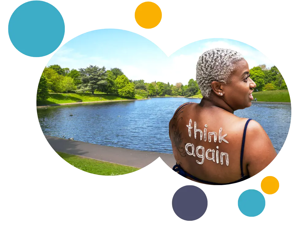 burnt woman in a park with 'think again' on her back in sunscreen