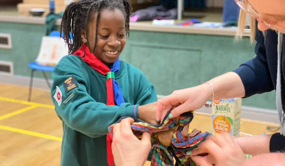young girl at scouts taking part in an experiment 